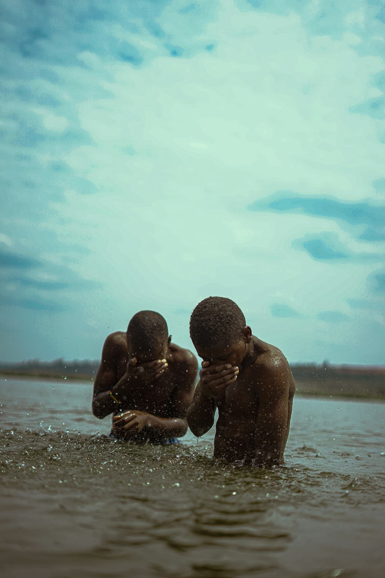 Two brothers in the water, quiet and reverent